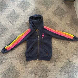 Aviator Nation Dark Blue Hoodie with Multicolor Stripes and bolt detail. Cozy